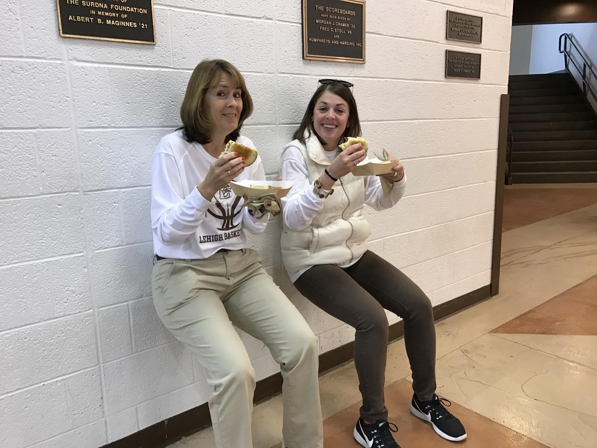 Katie Guynn (right) and Susan Szylagi (left) have fun with the wall sitting challenge.