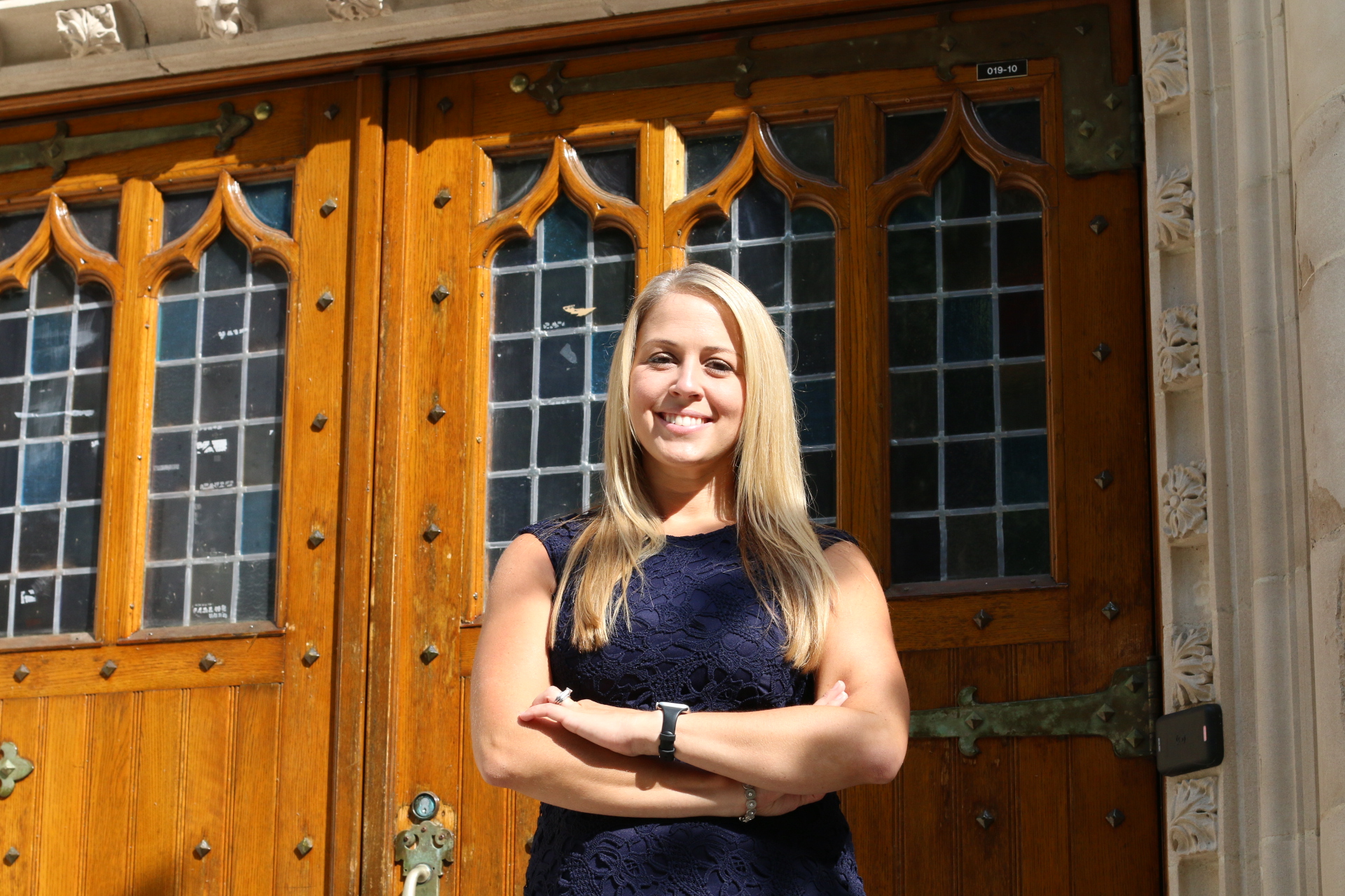 Lehigh staff member Ashley Baker stands outside Packard Lab smiling with pride after accomplishing her goal of earning a Master's Degree in educational leadership.