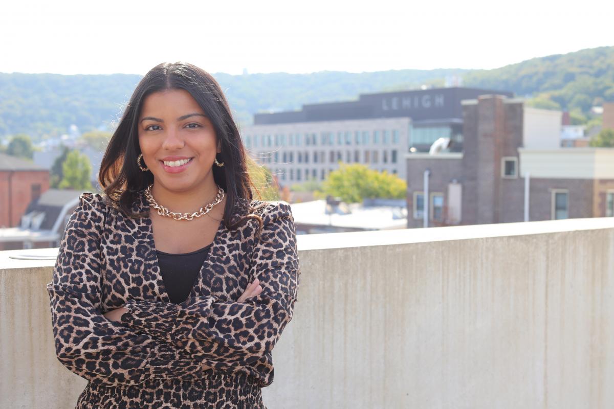 Human Resources Assistant Rebecca Barreto smiles with the Lehigh campus in the background