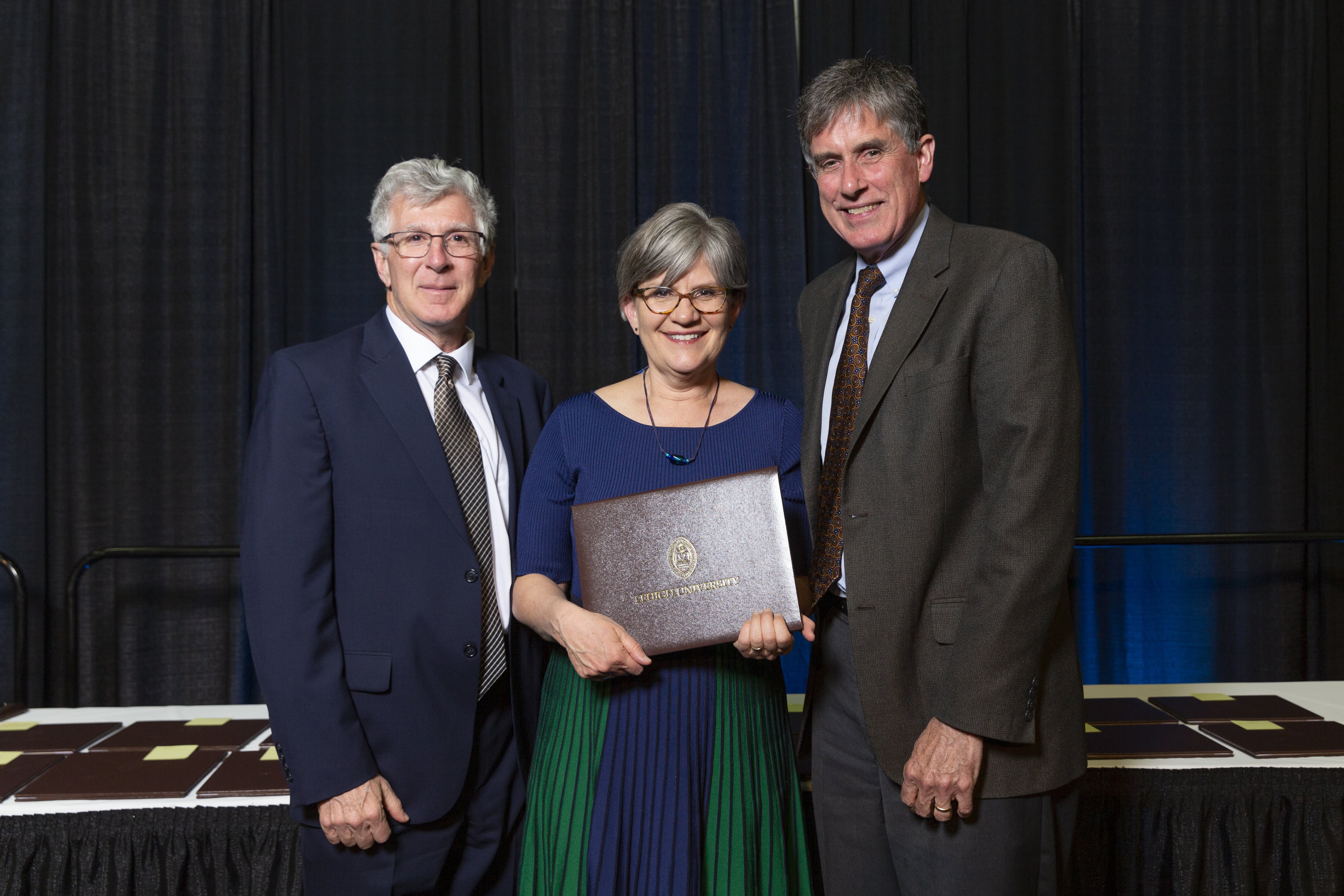 Kathleen Hutnik receives a 2019 Lehigh University Award from President John Simon and Provost Pat Farrell.