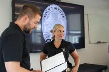Lehigh Police Officer Jaime Leauber looks at her colleagues as her supervisor Sergeant Kyle Fischer reads Jaime's Spot Bonus Award citation to her.