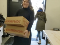 Community Schools Coordinator Paige Hoffman carries cartons of food into the Fountain Hill Elementary School Food Pantry