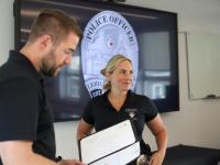 Lehigh Police Officer Jaime Leauber looks at her colleagues as her supervisor Sergeant Kyle Fischer reads Jaime's Spot Bonus Award citation to her.
