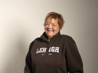 an image of MaryAnn Haller, a longtime Lehigh employee who passed away in November 2022. She is wearing a cozy brown Lehigh fleece sweater and smiling warmly.