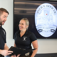 Sergeant Kyle Fisher awards an officer with a Spot Bonus Award