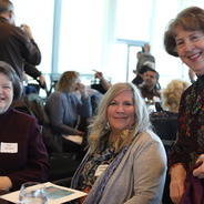 colleagues smile as they reconnect at the 25 year club luncheon in fall 2023