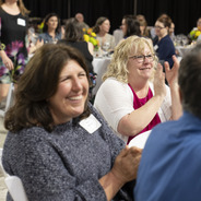 smiling employees celebrate their colleagues at the annual staff appreciation dinner