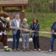 Lehigh staff and faculty cutting the ribbon at Forest Park's first open trail.